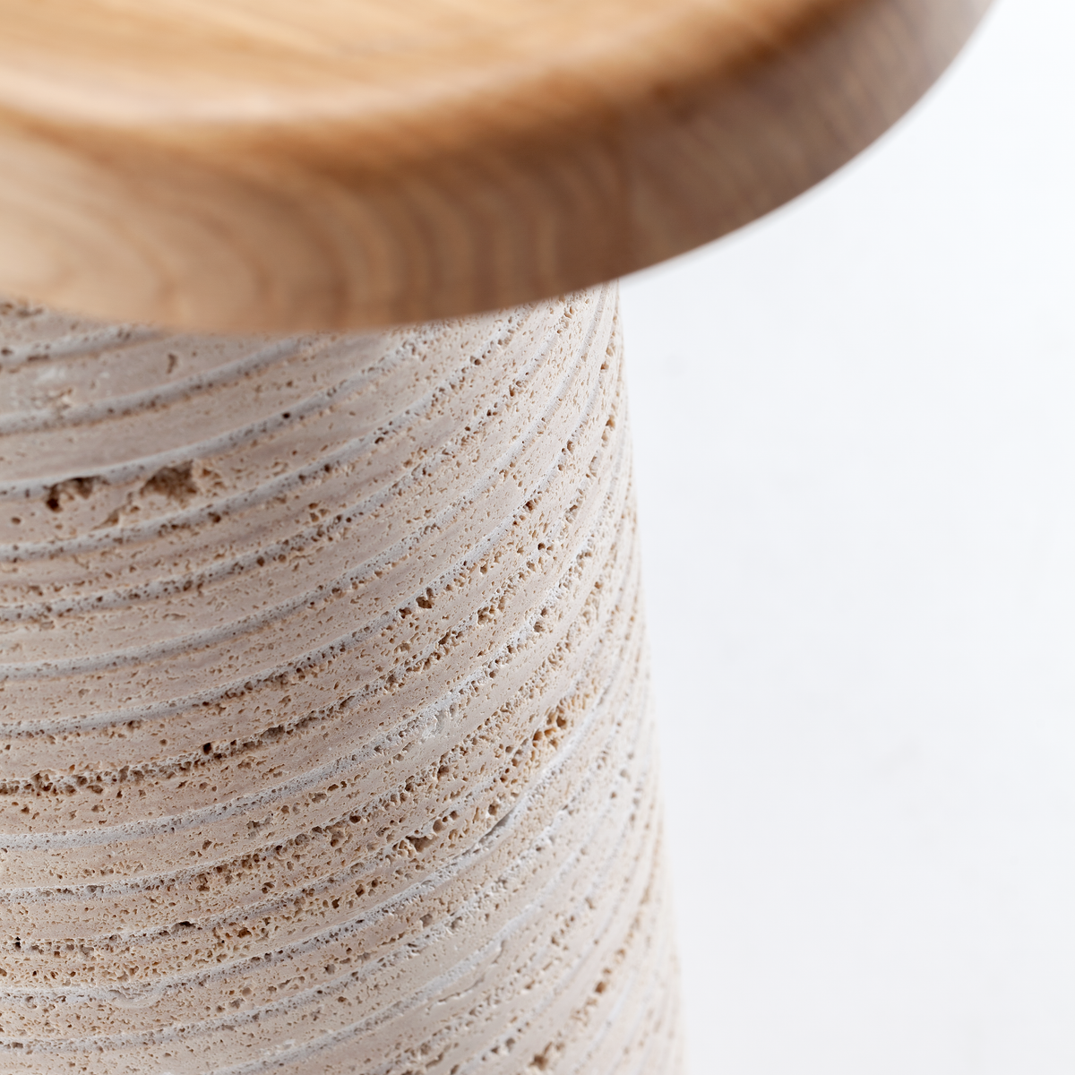 Poppy Console Table close-up of the oak top edge over the ribbed travertine leg