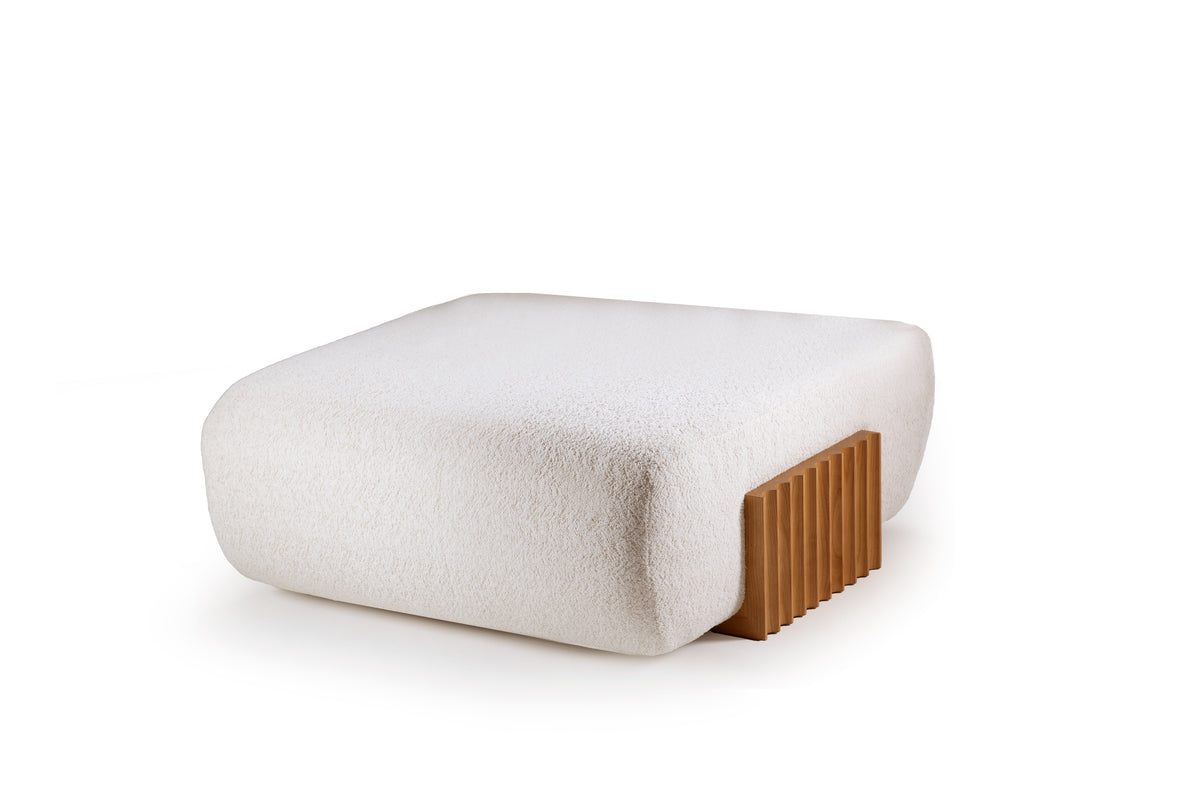 Carmel Ottoman in white boucle with a fluted wood base, three-quarter view