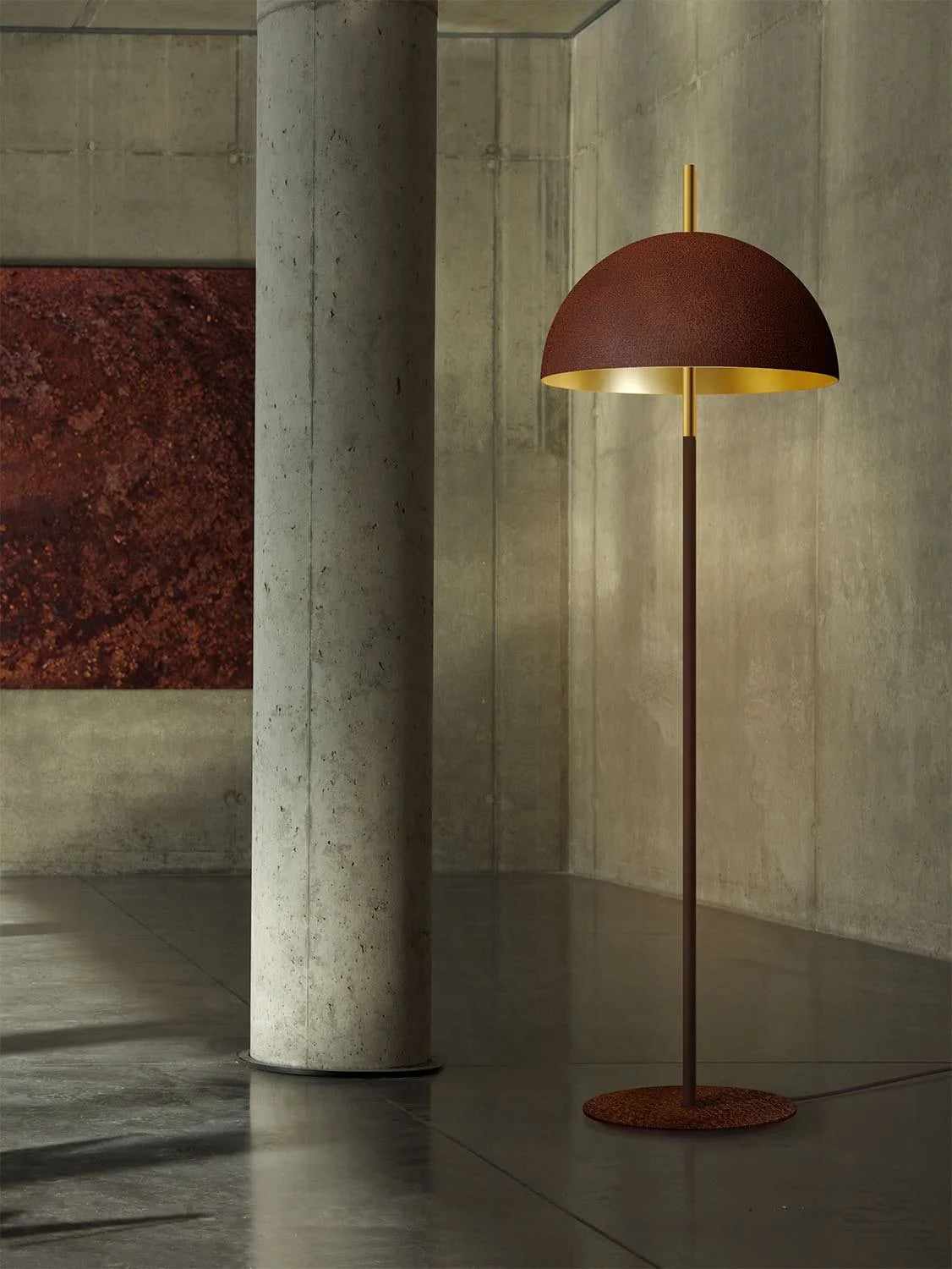 Mammalampa Queen Floor Lamp with corroded steel dome and gold interior by a concrete column