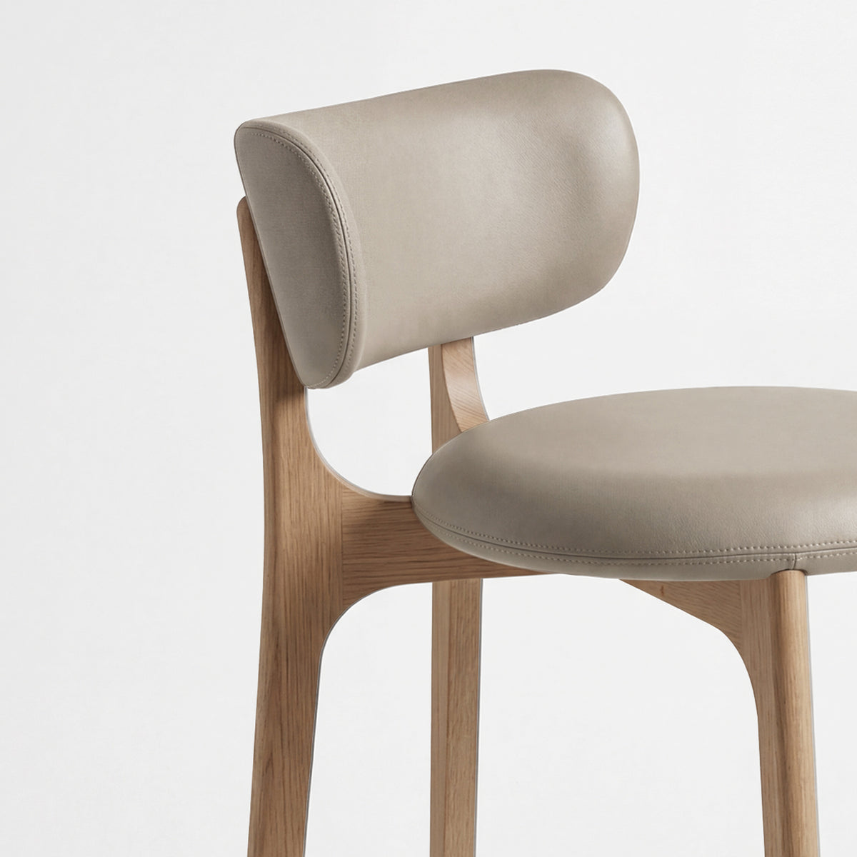 Richmond Bar Stool close-up of taupe leather seat, curved back and oak frame