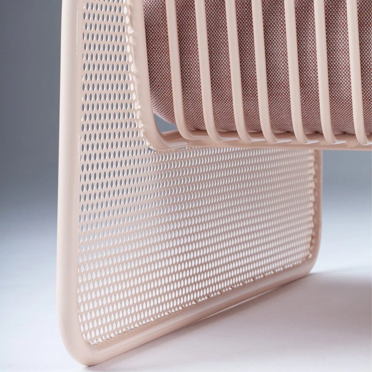 Riviera Modular Sofa - 1 Seat detail of the perforated metal panel and tubular blush frame