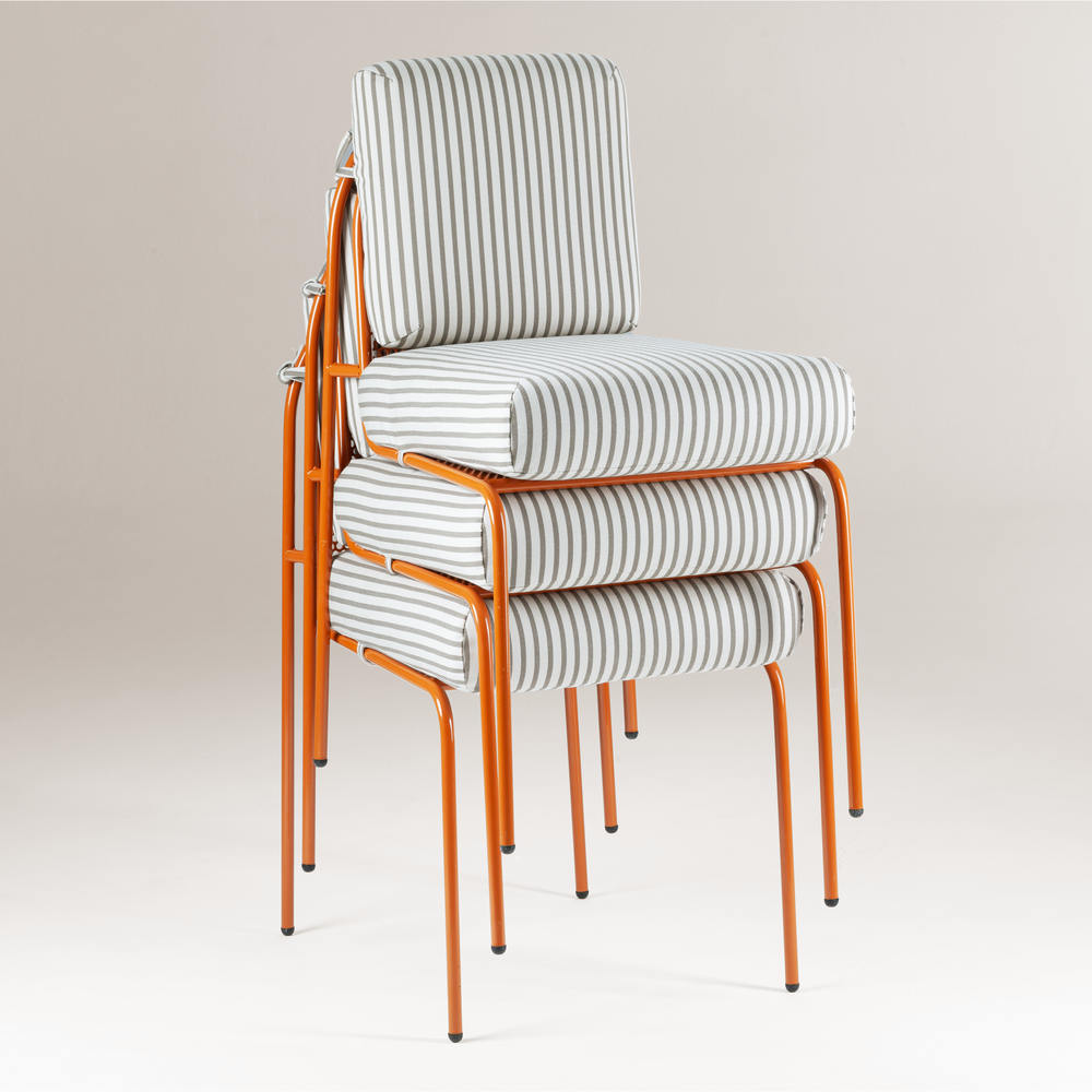 Riviera Chair stacked three high in stripe upholstery with terracotta frames
