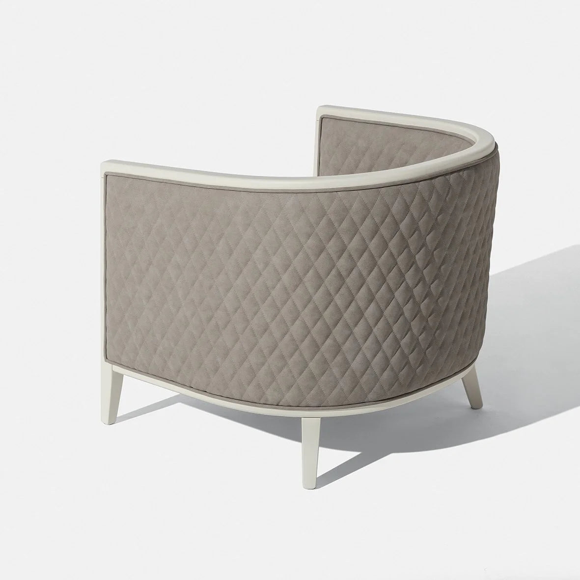 Saten Armchair in quilted taupe, back view of the curved shell