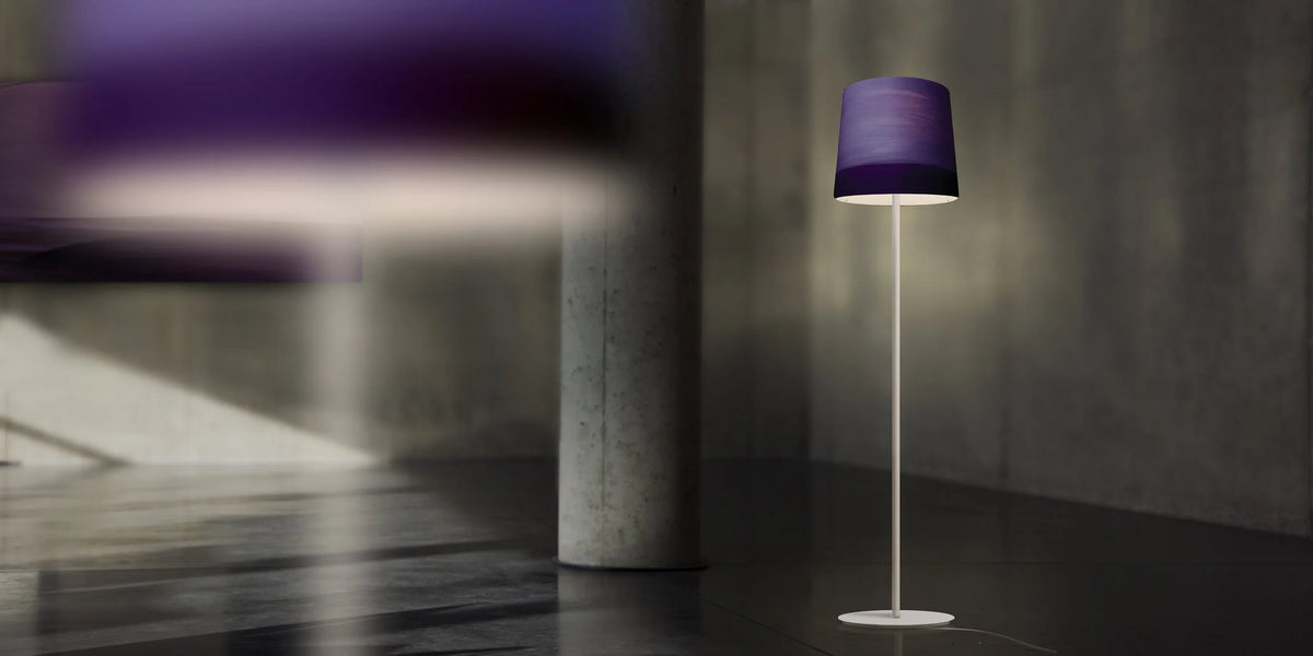 Mammalampa Sisters Floor Lamp in Evening, purple shade in a concrete room