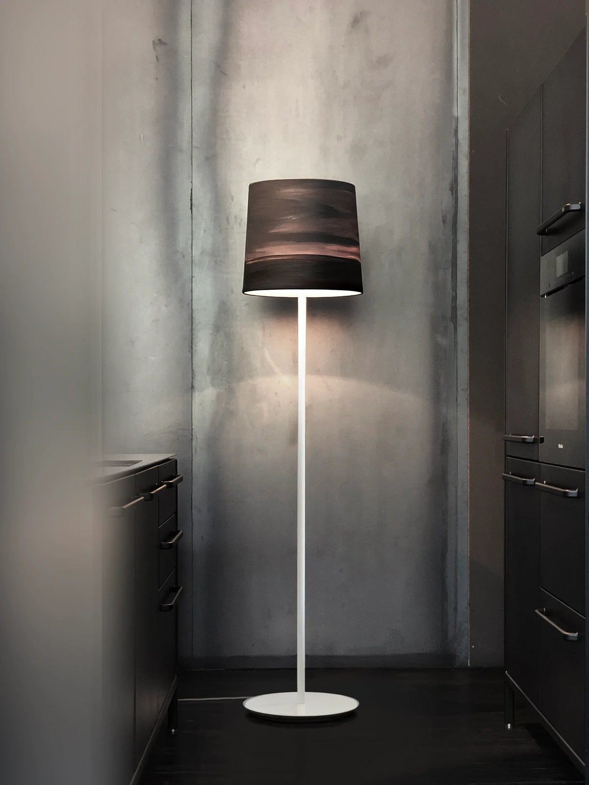 Mammalampa Sisters Floor Lamp in Mist standing in a dark grey kitchen corner