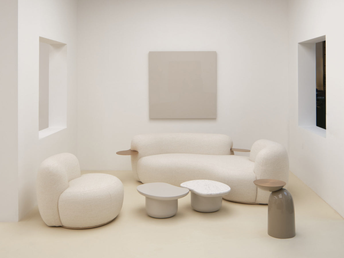 Tateyama Curved Sofa in cream boucle with a matching armchair and round side tables