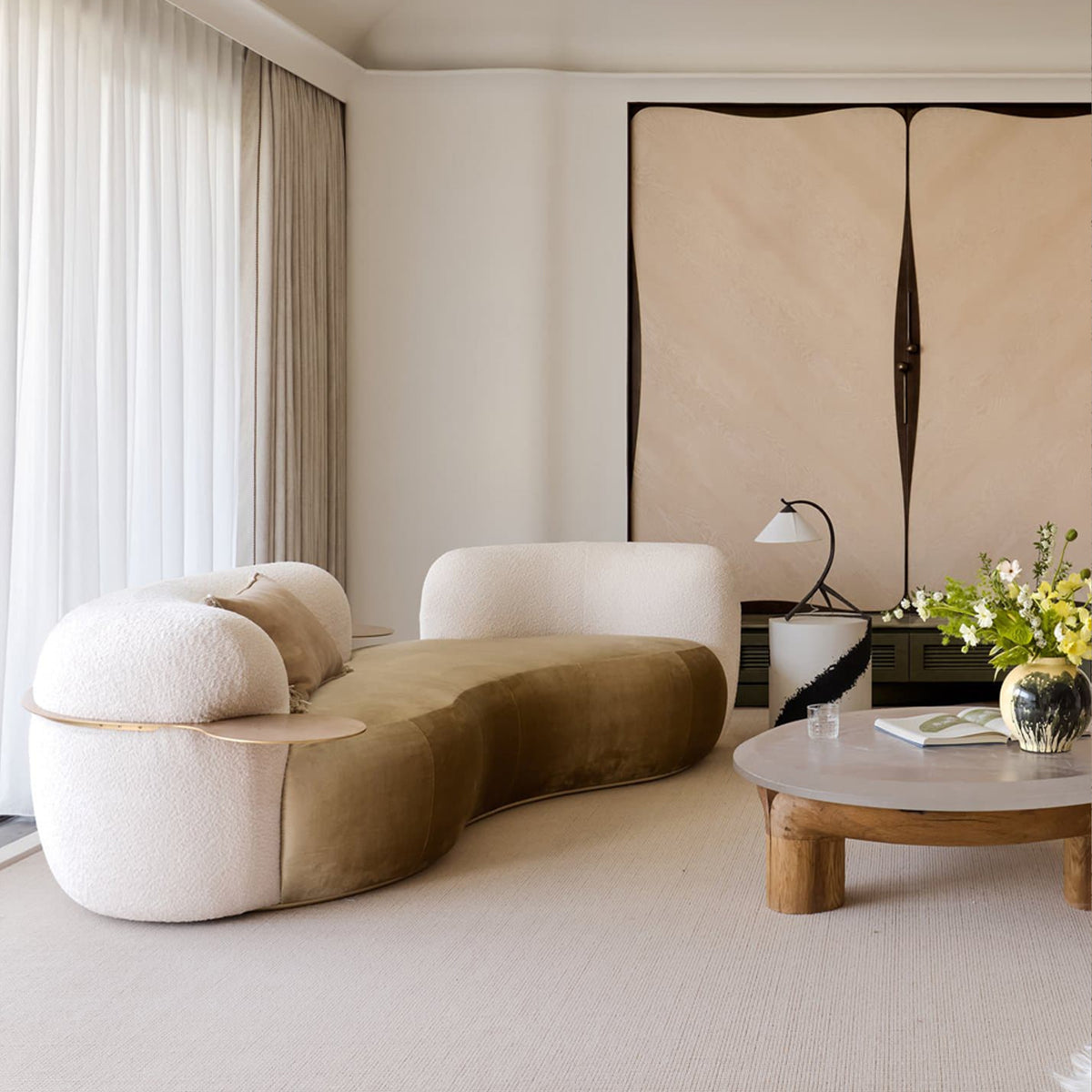 Tateyama Curved Sofa in cream boucle and olive velvet with a round wood coffee table