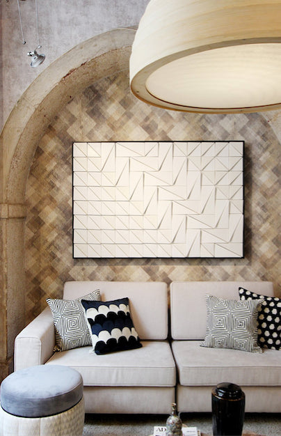 Tejo Panel in Ivory above a beige sofa with patterned cushions