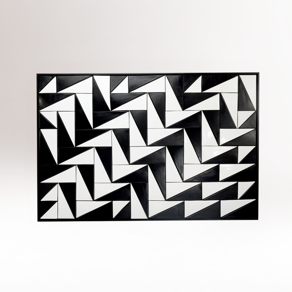 Tejo Black & White Panel with pinwheel triangle pattern on a white wall