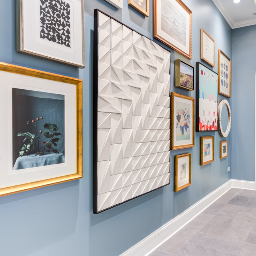 Tejo Panel in Ivory on a blue gallery wall among framed art