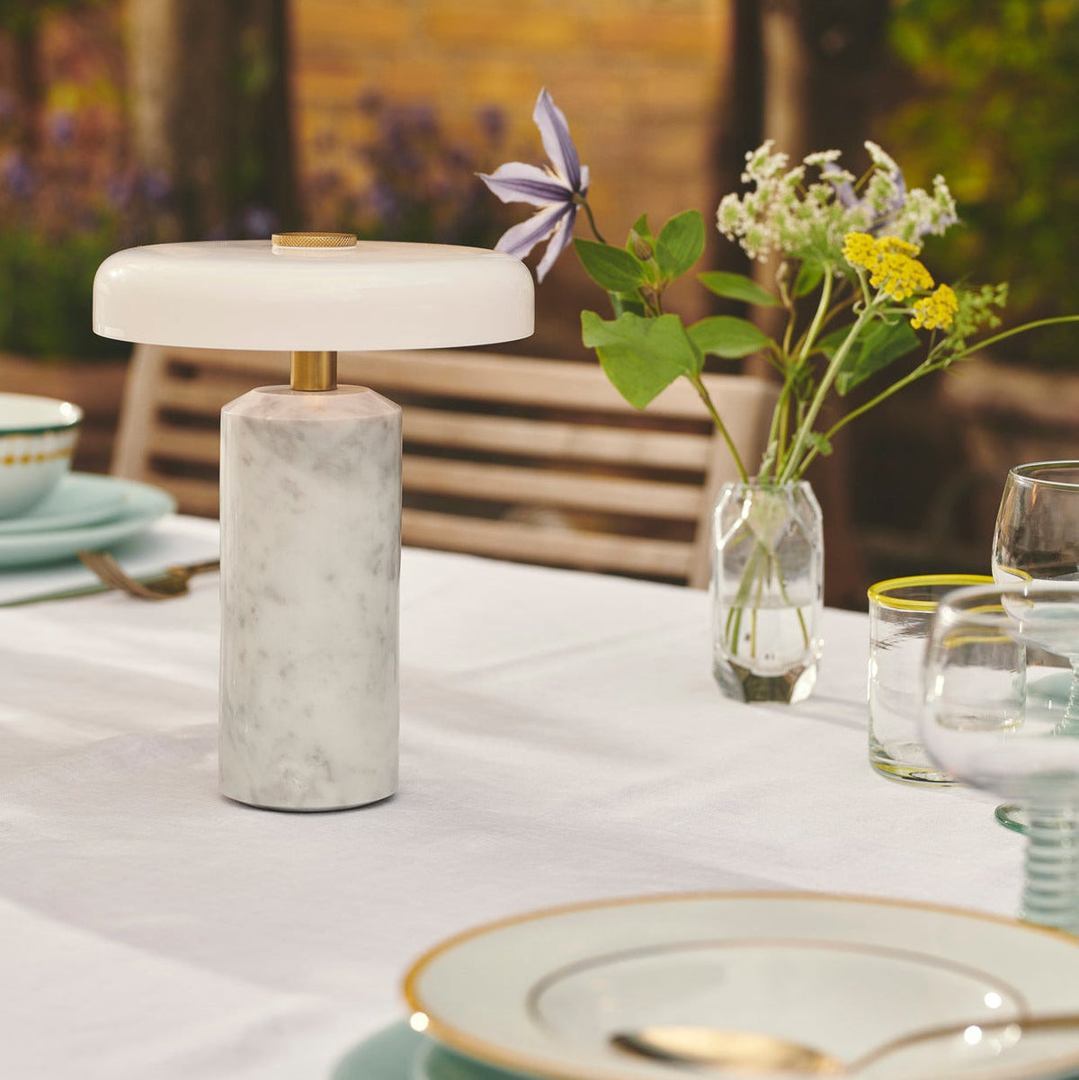 Trip Table Lamp – Carrara | Opal close-up on a white tablecloth with wildflowers