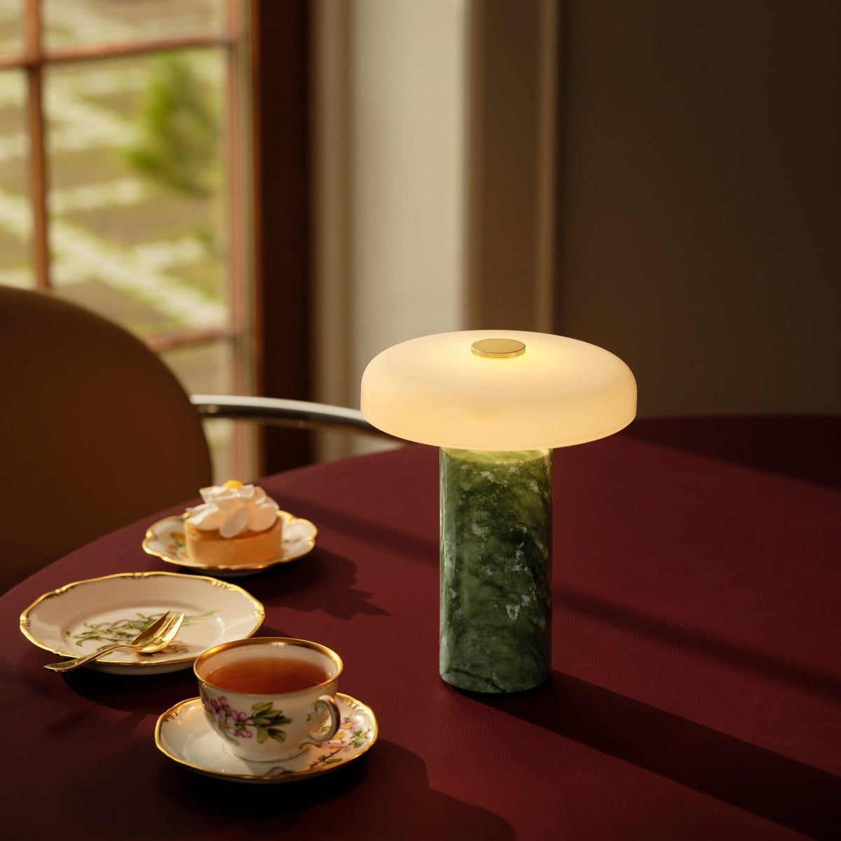 Trip Table Lamp in Apple / Opal on a burgundy tablecloth with tea and cake