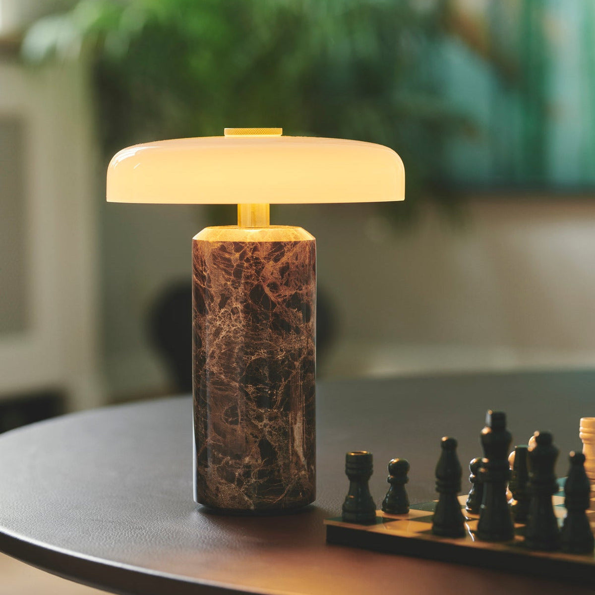 Trip Table Lamp in Dark Emperador / Opal lit beside a chessboard