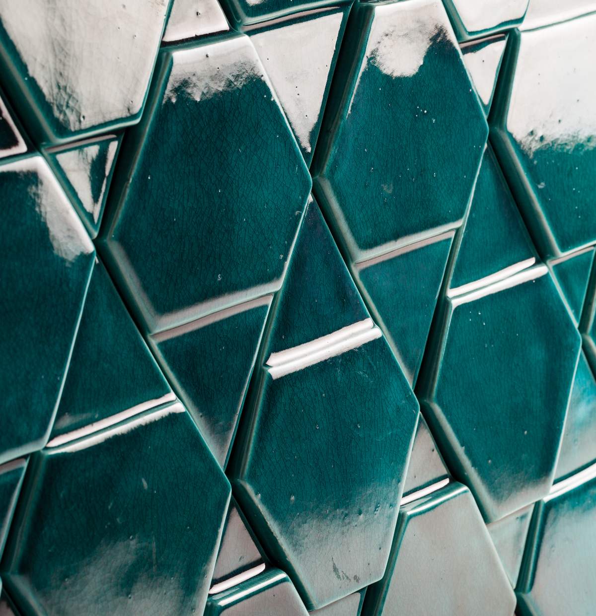 Tua Panel close-up of glossy teal glazed relief tiles