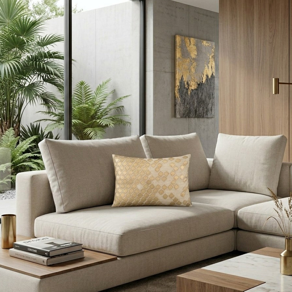 Verona Gold Pillow on a beige sofa beside tall windows and greenery