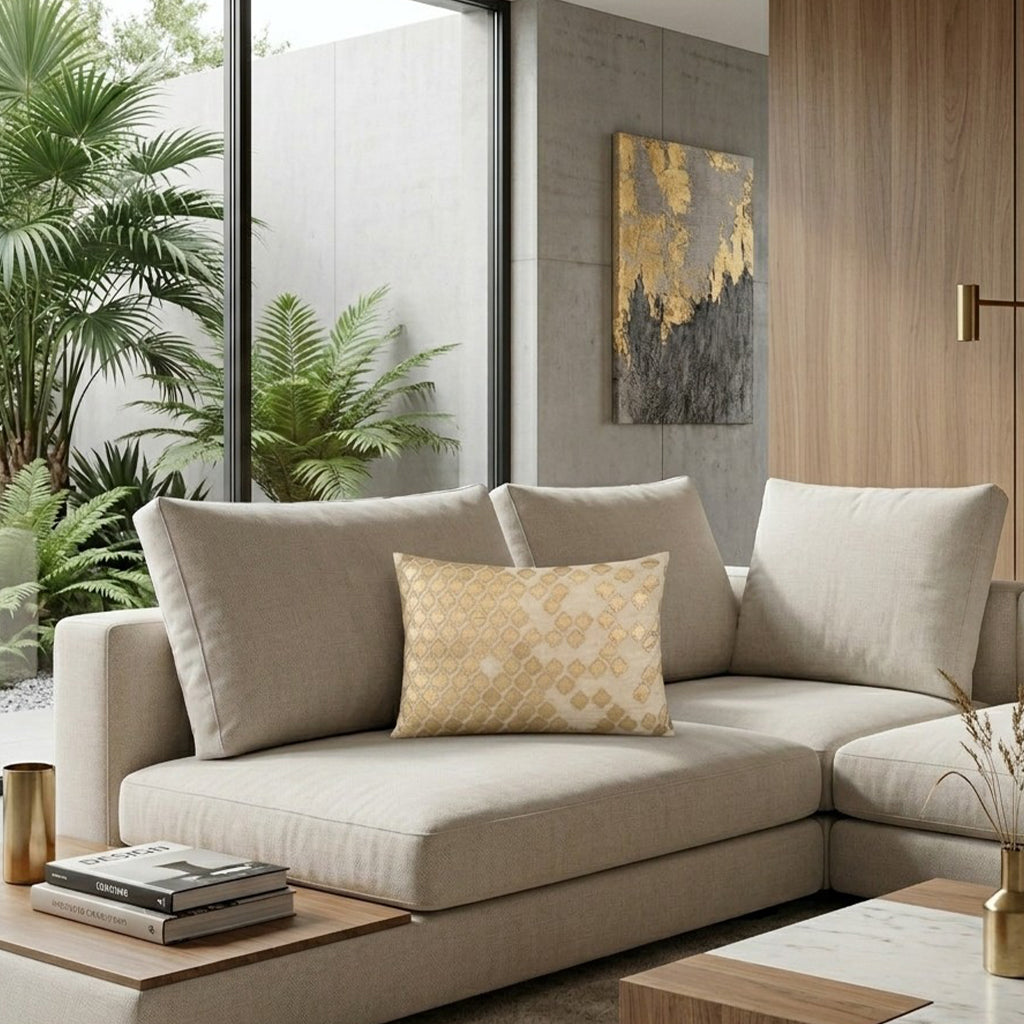 Verona Gold Pillow on a beige sectional in a living room with gold abstract art