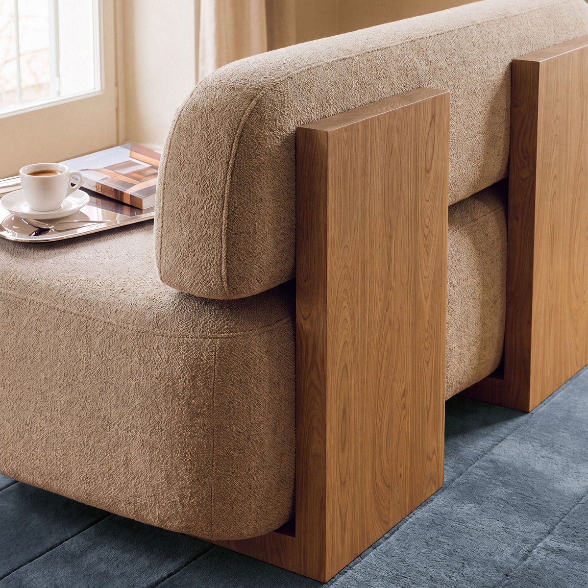 Yoshida Sofa close-up of oak side panel and sand bouclé cushion