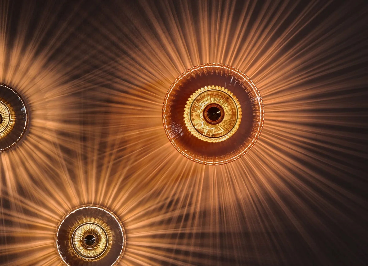 Disco-Rama wall sconces casting radiant light patterns