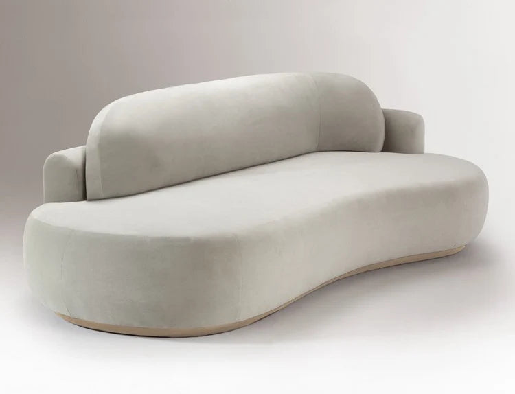 Curved light grey round sofa with a low rounded back