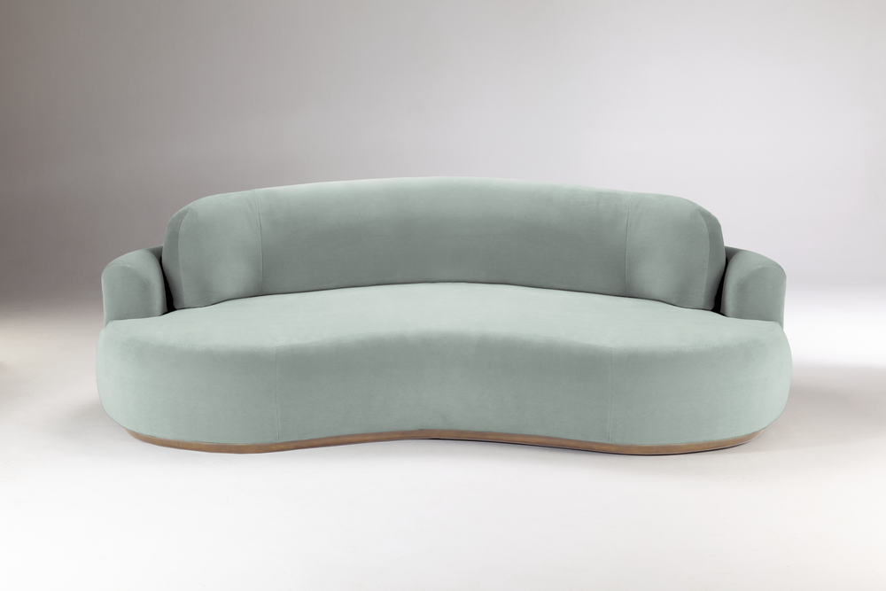 Curved sage green round sofa on a slim wood base