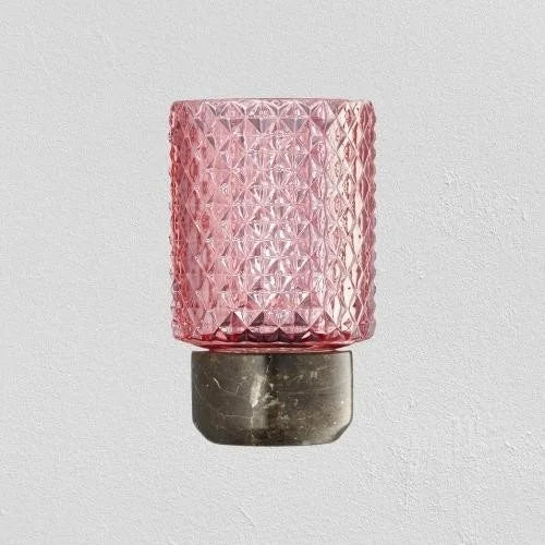 Pink cut-glass candle holder on a grey marble base