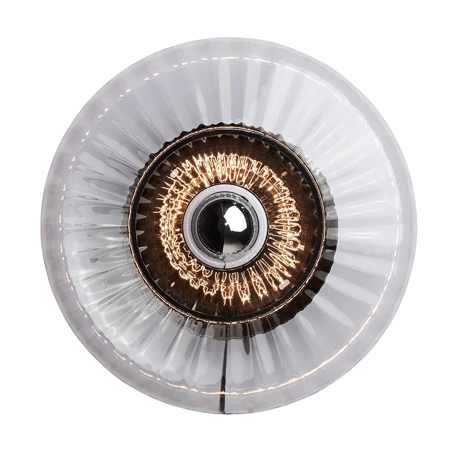 New Wave Optic wall sconce in ribbed clear glass with a glowing filament bulb