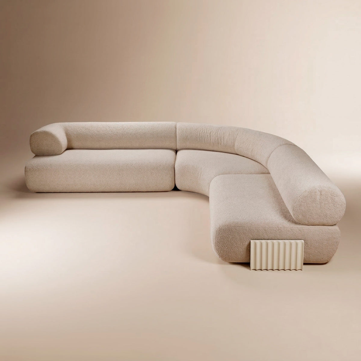 Curved modular sectional sofa in cream boucle