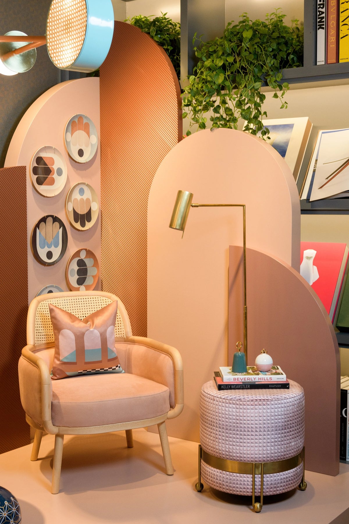 Luc Armchair in blush fabric in a peach room with a brass floor lamp