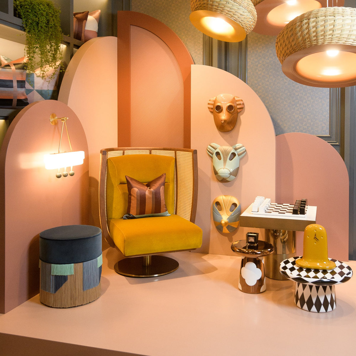 Egoista Armchair in mustard velvet in a pink arched display with sculptural decor