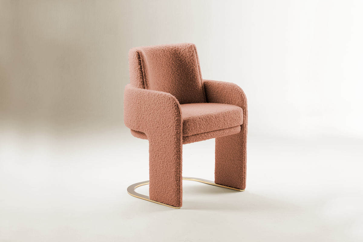 Odisseia Dining Chair in dusty pink bouclé on a soft studio backdrop