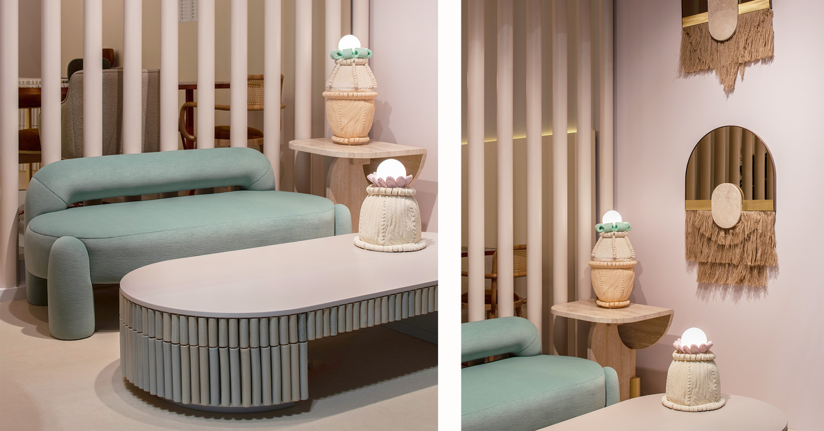 Playing Games Travertine Side Table in a pink lounge with a green sofa