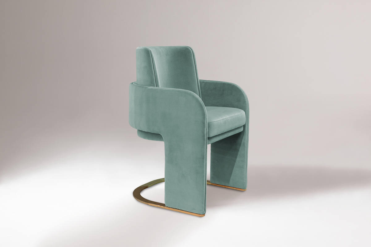 Odisseia Dining Chair in seafoam velvet with brass base, three-quarter view
