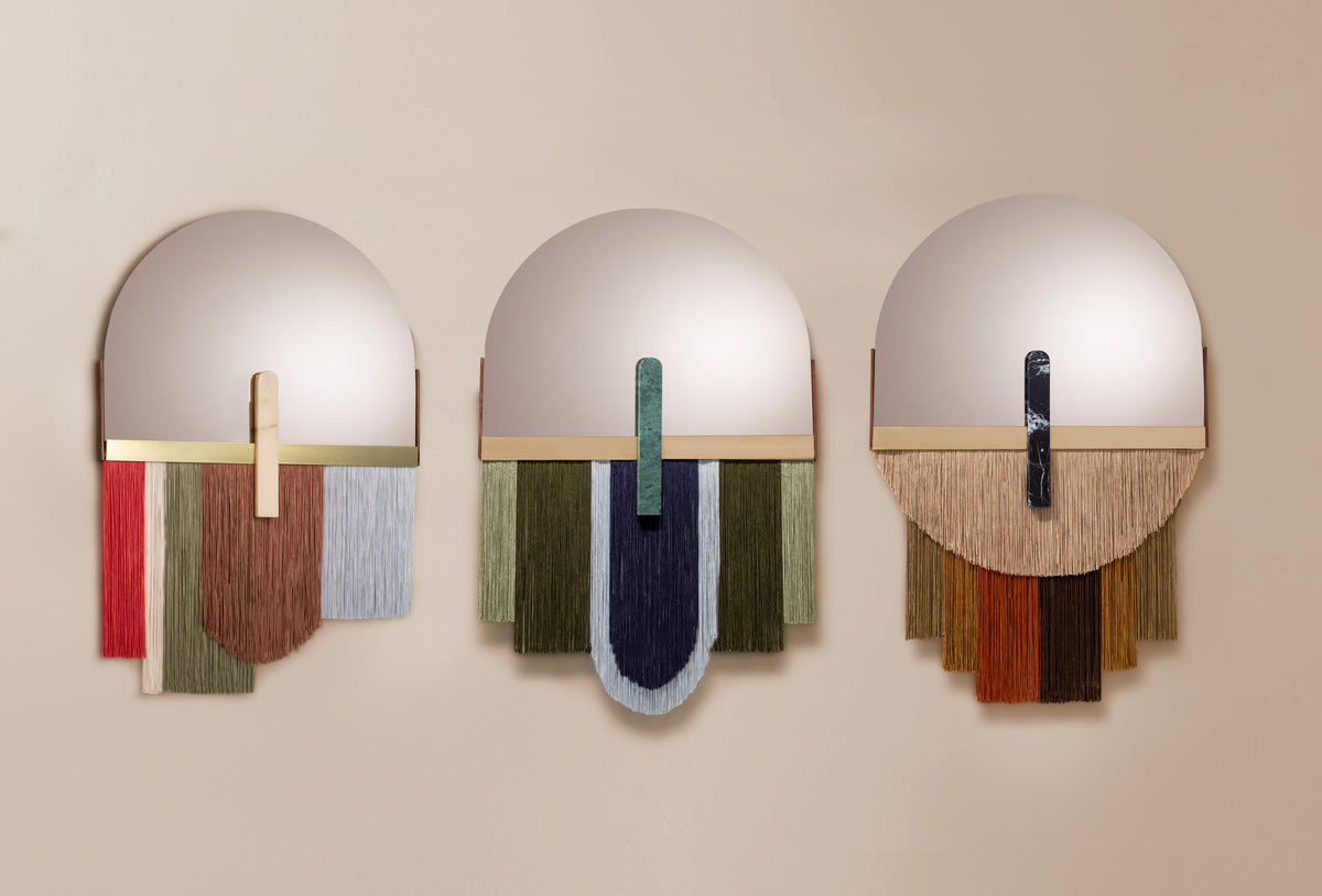 Souk Mirror Caramel beside two colorway variants with fringe on a wall