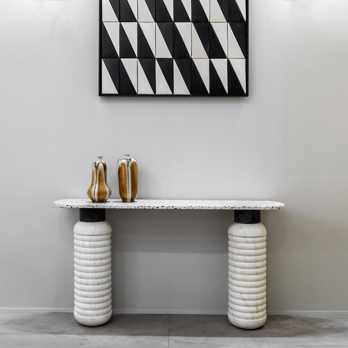 Jean Console Table with Terrazzo White top and white ribbed columns under geometric art