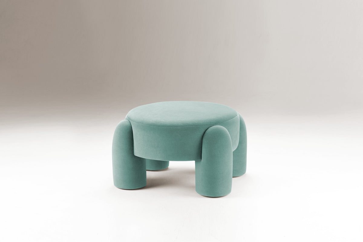 Marlon Pouf in aqua green on a grey backdrop