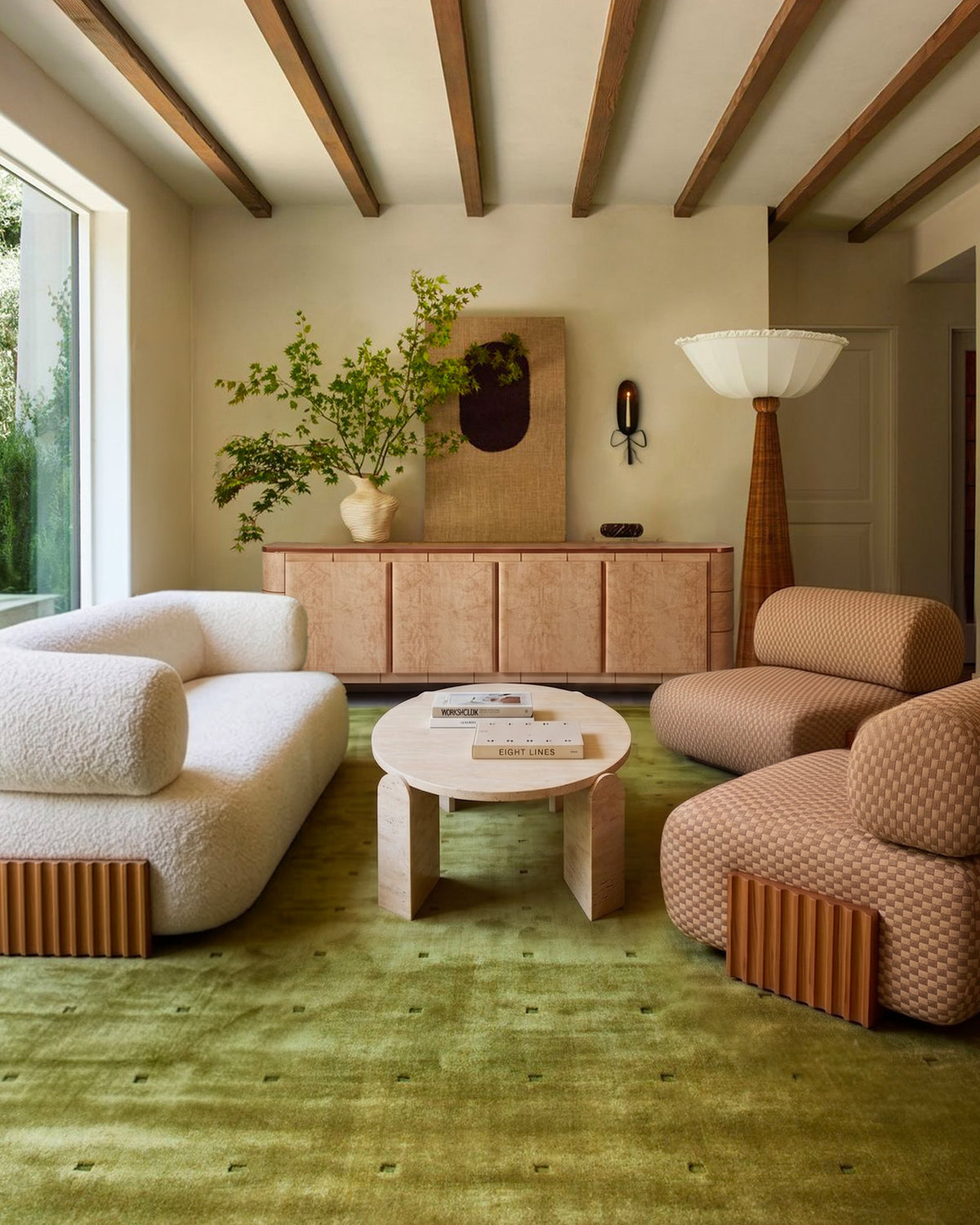 Soft Cage Sideboard in a living room with a green rug and terracotta armchairs
