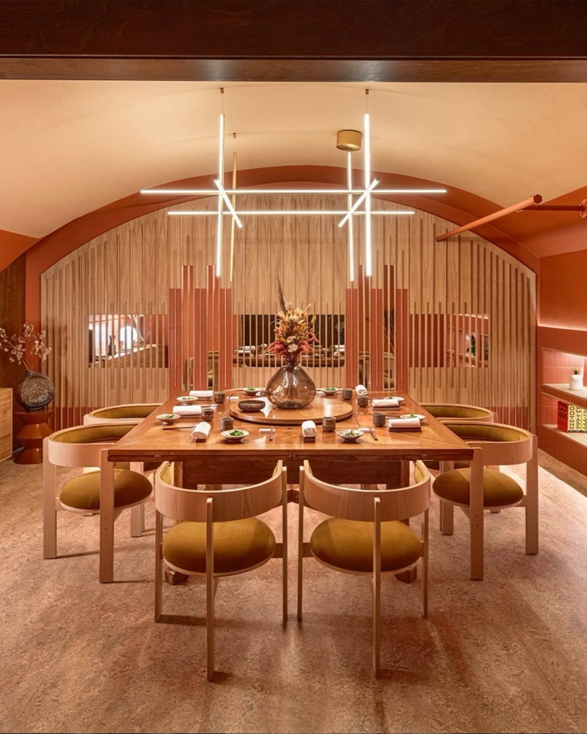 Moulin Dining Chairs in mustard around a wood table in a terracotta vaulted dining room