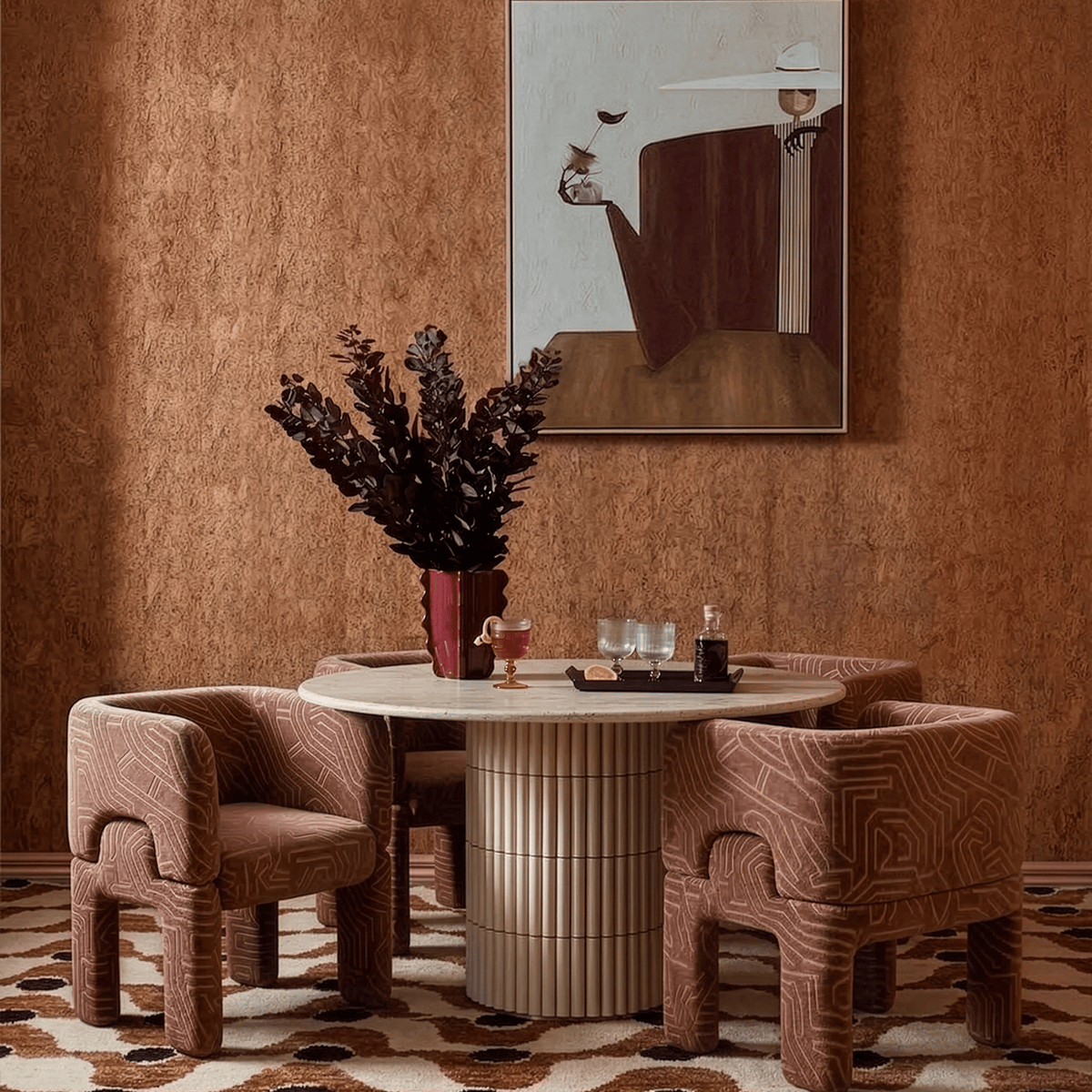 Nouvelle Vague Dining Table with terracotta armchairs in a cork-walled room