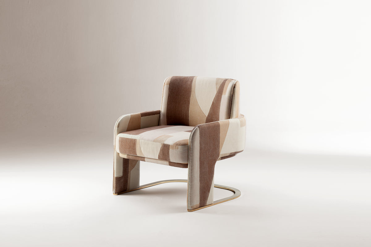 Odisseia Armchair in patterned blush fabric, studio three-quarter view
