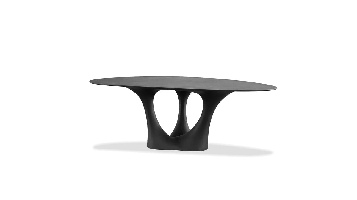 Groot Dining Table with dark oval top and sculptural base, front view