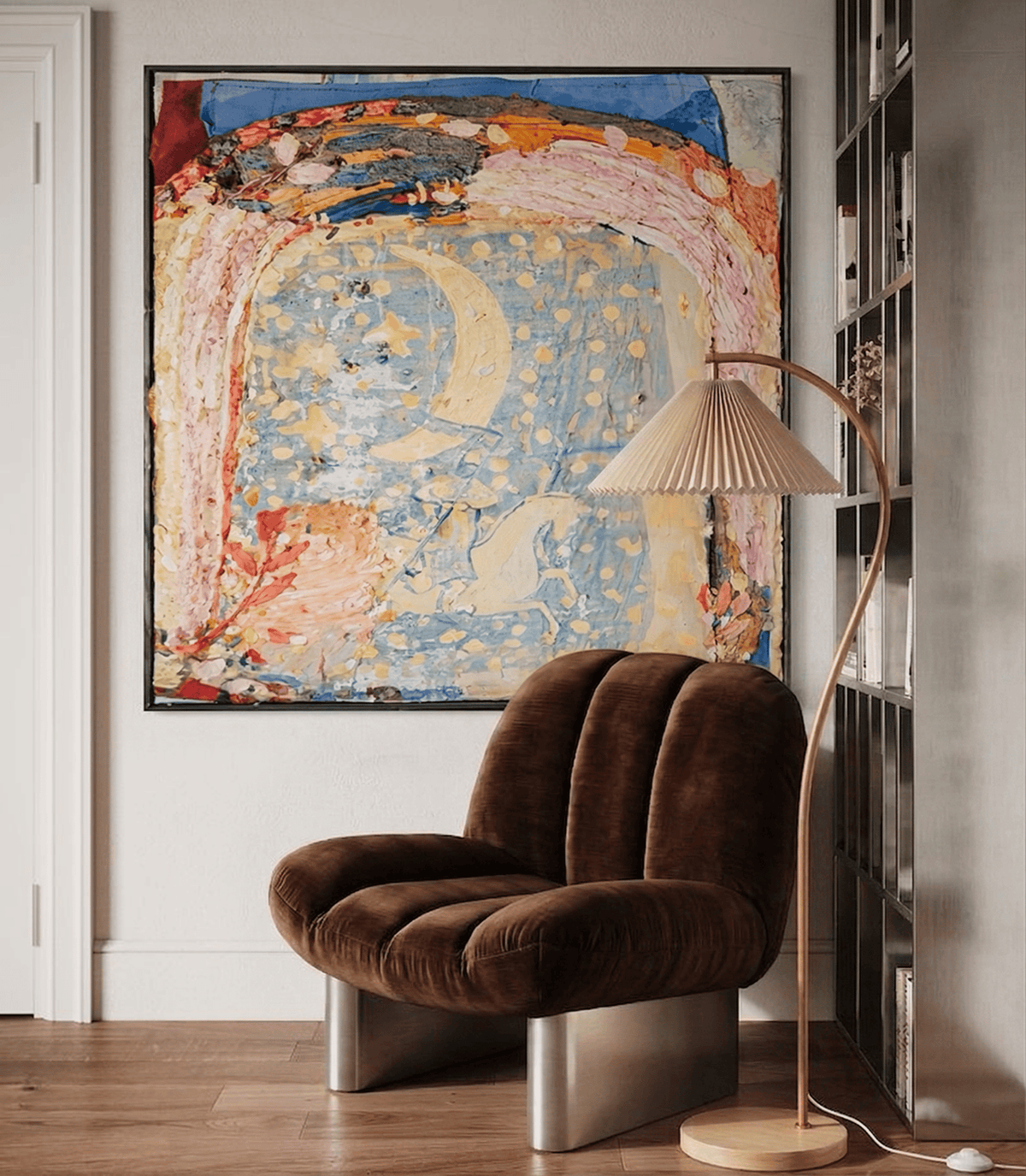Colin Armchair in brown velvet with metal base beside a pleated floor lamp and abstract painting