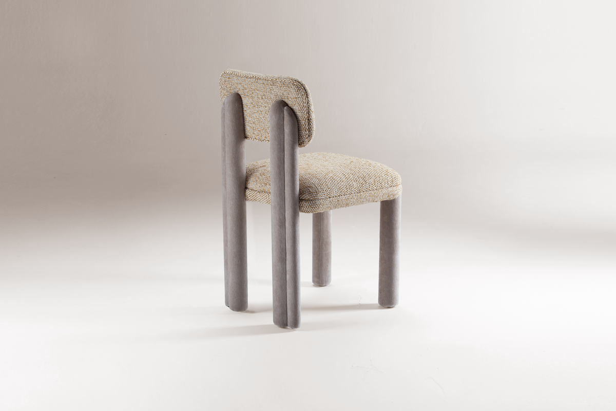 Camelia Dining Chair in oatmeal bouclé with grey legs, three-quarter view