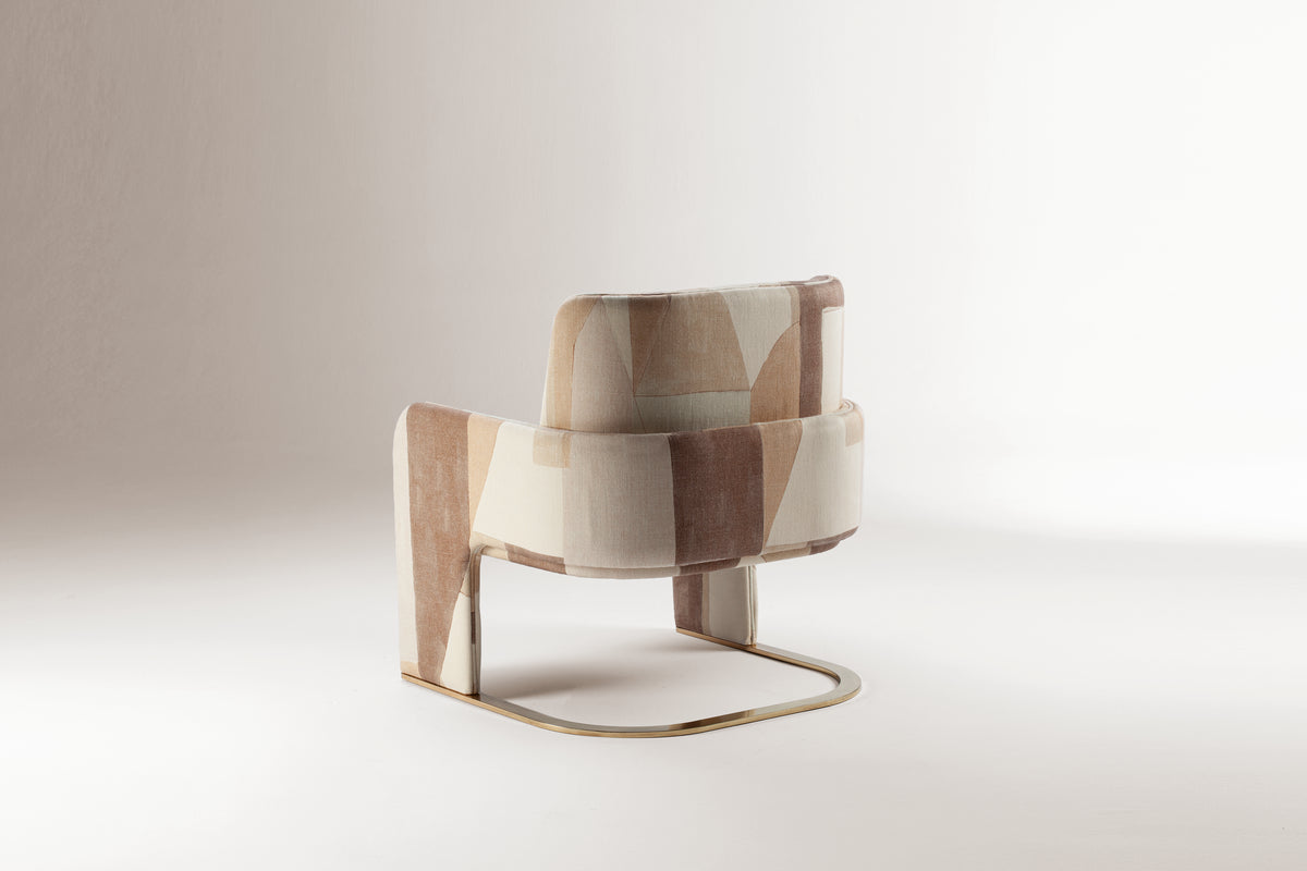 Odisseia Armchair in patterned fabric, rear view showing brass sled base