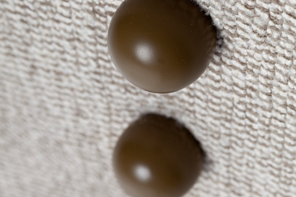 Panorama Armchair close-up of round wooden buttons on textured weave