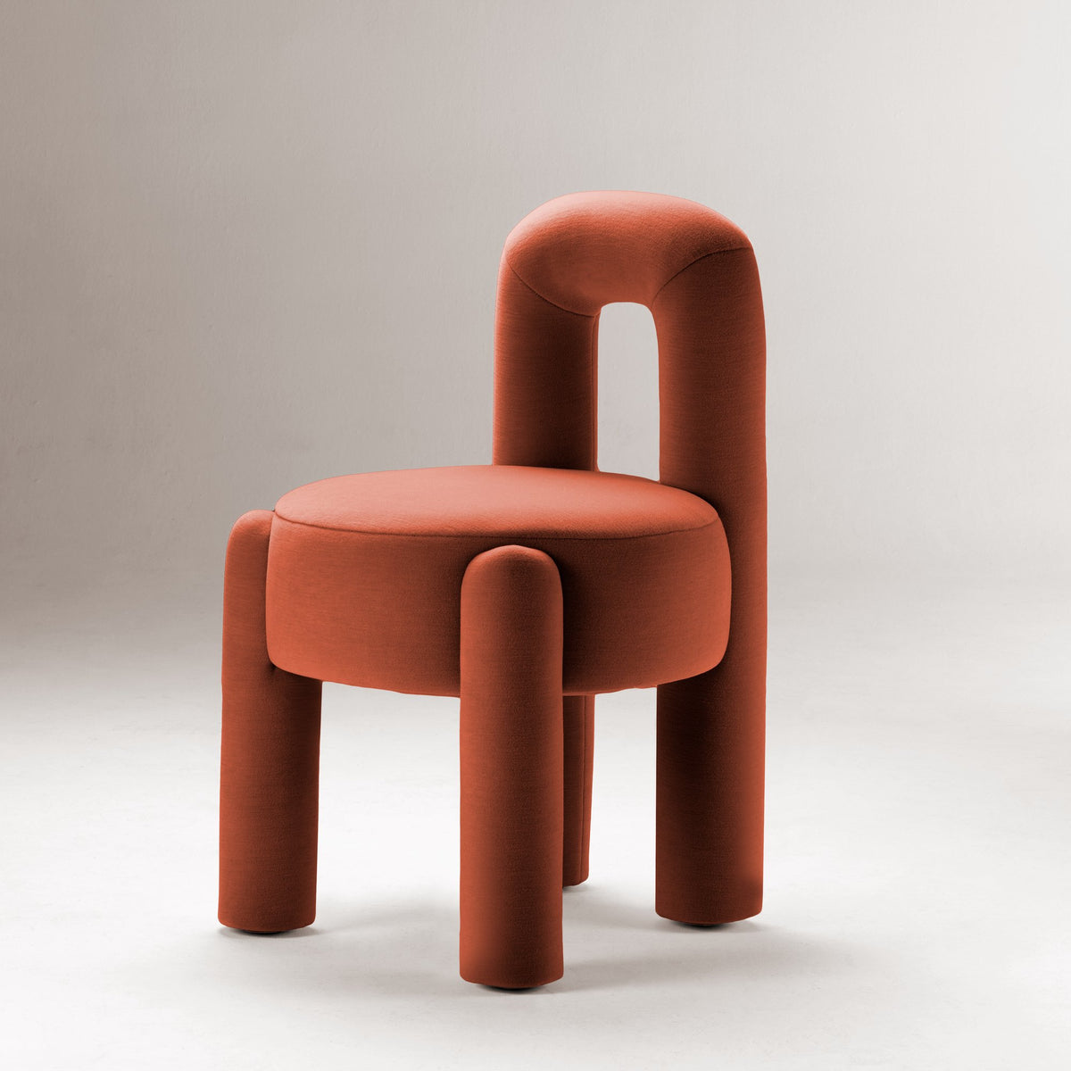 Marlon Chair in rust velvet on a grey studio backdrop