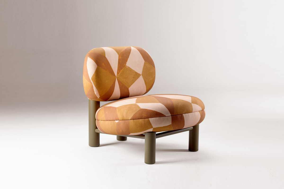 Aimi Lounge Chair in orange geometric fabric with olive legs, front three-quarter view on grey
