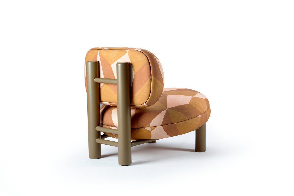 Aimi Lounge Chair in orange geometric fabric, back three-quarter view with olive ladder frame