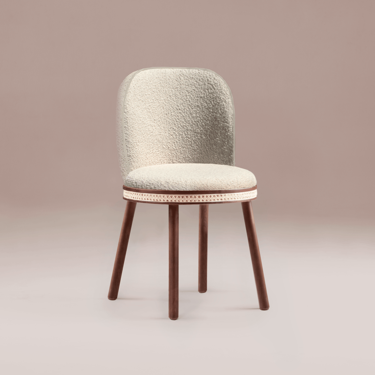 Alma Dining Chair in ivory bouclé with walnut legs on a pink backdrop