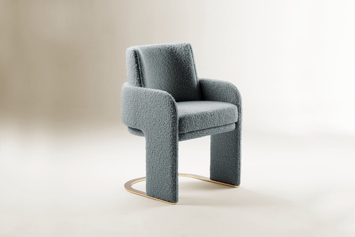 Odisseia Dining Chair in blue-grey bouclé on a soft studio backdrop