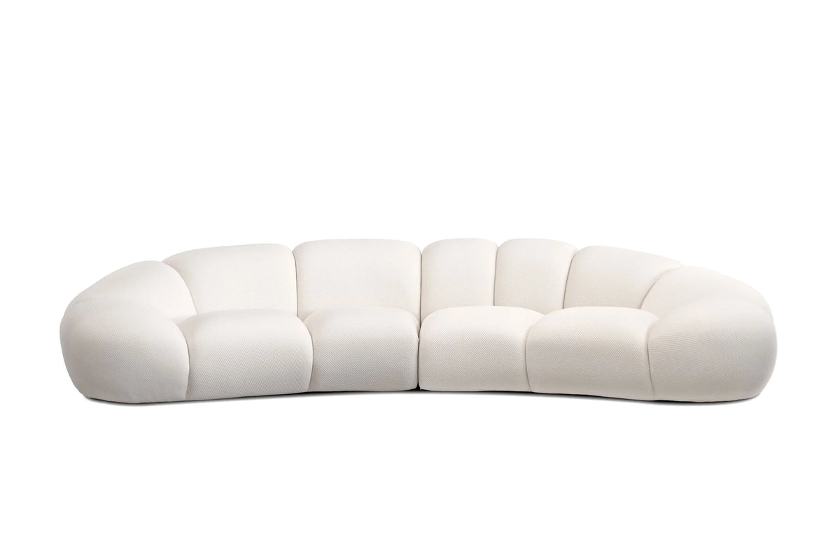 Cirro Sofa - 4-Seater in Buttermilk, front view of curved channel-tufted sofa